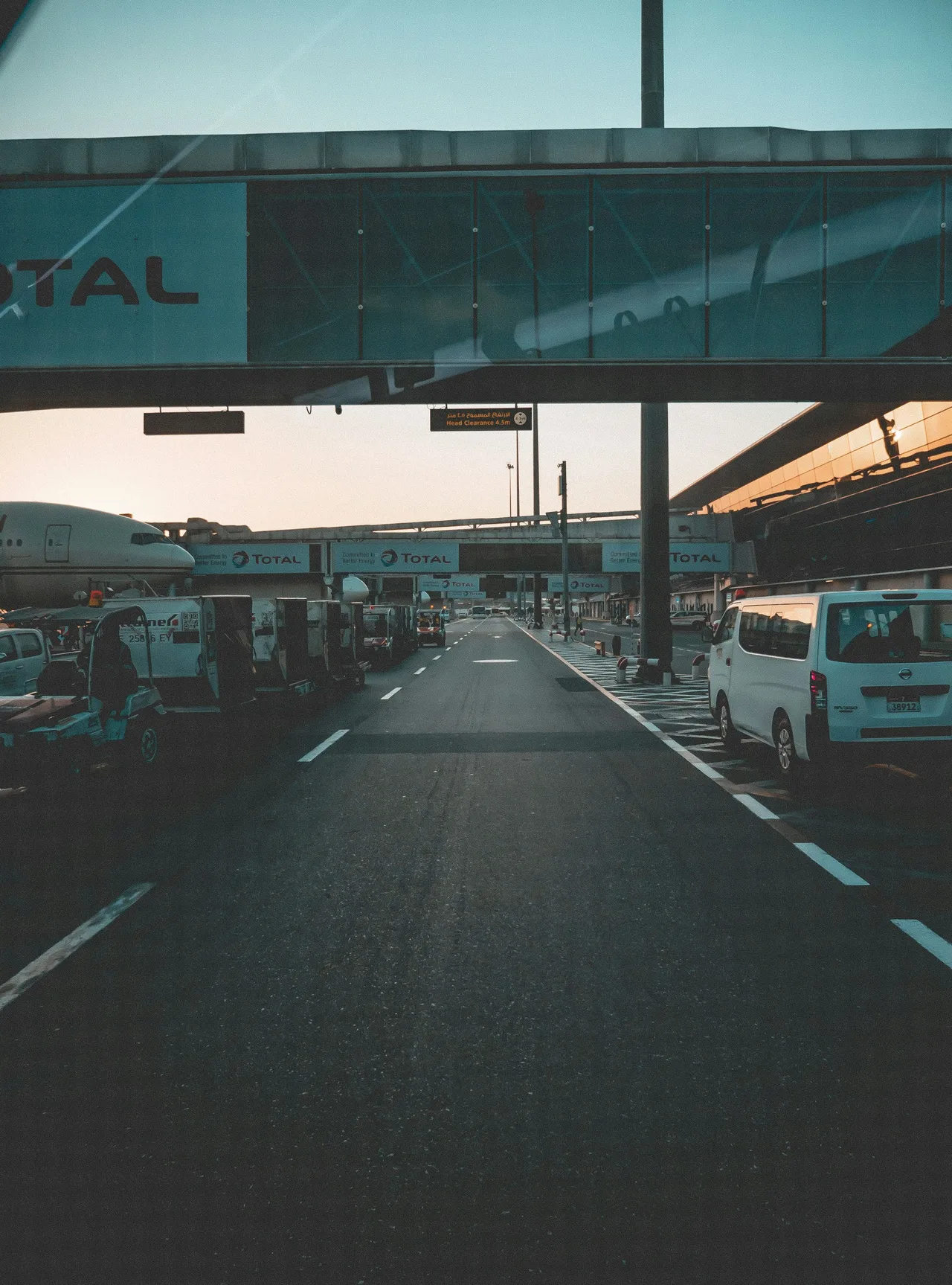 White private transfer van on the road during the day